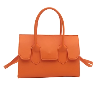 Bright orange matte faux leather tote bag with minimalist flap and top handles