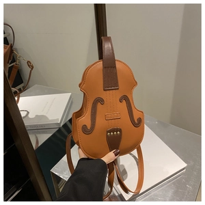 Detail view of the violin-shaped handbag with intricate stitching and handle features