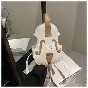 Detail of creative violin-shaped crossbody bag with white PU leather and brown accents