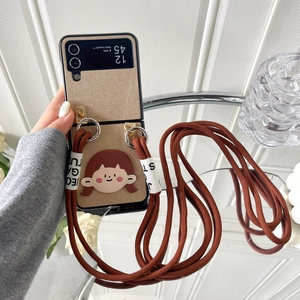 Detailed view of Z Flip6 case with cute cartoon charm and brown crossbody strap accessory
