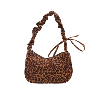 Leopard print hobo bag with pleated shoulder strap and ribbon detail on white background