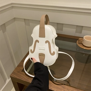 Creative violin-shaped crossbody bag in cream and brown leather with shoulder strap