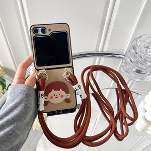 Detail of crossbody strap attachment on flip phone case with cute cartoon girl decor