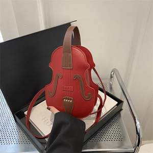 Creative violin shaped crossbody bag in red faux leather with elegant vintage hardware