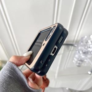 Close-up of black folding phone case with rose gold trim and precision side cutouts