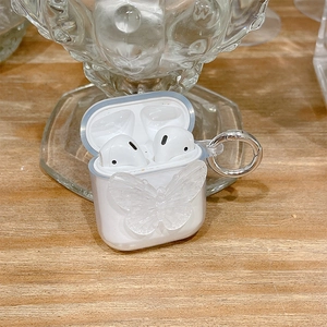 Detail of clear AirPods case with 3D butterfly decor and silver metal carabiner