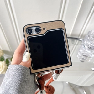 Close-up of champagne gold glitter folding phone case with crossbody strap and detail tag