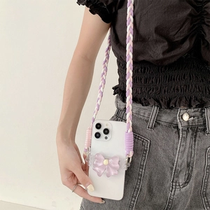 Crossbody phone strap with purple bow case shown as a stylish wearable accessory