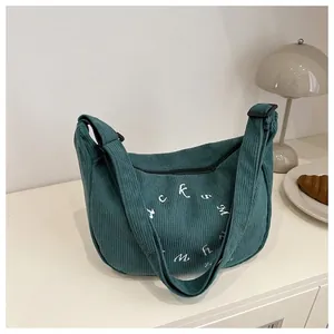 Minimalist dark green corduroy tote bag with embroidery and adjustable shoulder strap