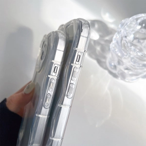 Close-up of clear shockproof iPhone case side buttons and precise cutouts on glass texture
