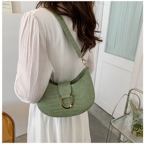Detail showing mint green crocodile pattern hobo bag with a stylish gold U-shaped buckle