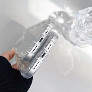 Macro detail of clear wavy phone case showing precise charging port and speaker cutouts