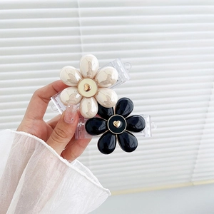 Detail of flower hair clips with glossy finish and gold heart center set of two