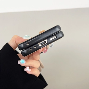 Close-up of precise cutouts for USB-C port and speakers on black leather Galaxy Z Flip case