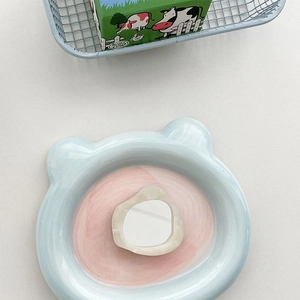 Close-up of bear-shaped ceramic plate in blue and pink tones for creative table decor