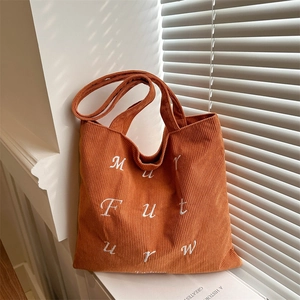 Caramel corduroy tote bag with white embroidered letters and dual handles for women