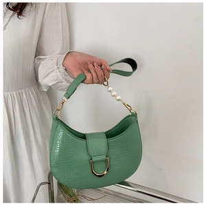 Detail of light green crescent bag with croc-effect texture and pearl chain handle