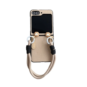 Cream leather case for Samsung Z Flip 5 with heart charms and woven wrist strap