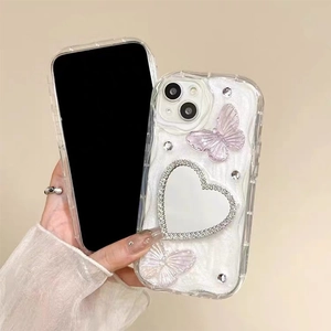 Sparkly butterfly phone case with heart mirror and rhinestones on wavy glitter background