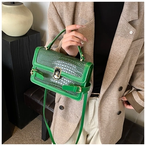 Detail of green crocodile texture PU leather crossbody bag with gold metal buckle