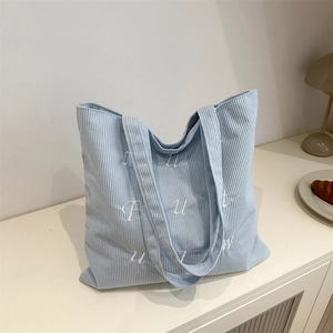 Light blue corduroy tote bag with white letter embroidery for casual daily commuting