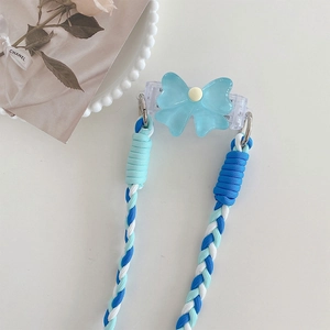 Adjustable blue bow phone strap with thick braided rope and metal rings on white table