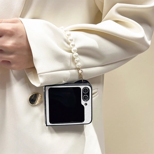 Z Flip5 phone case featuring a pearl wrist strap and minimalist black white contrast design