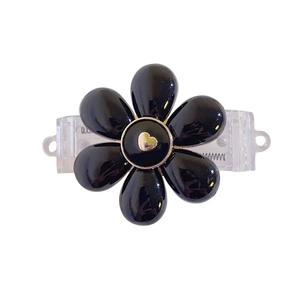 Black flower hair claw clip with golden heart detail and transparent base for women