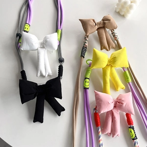 Adjustable padded bow phone crossbody strap in five colors with cute smiley face detail