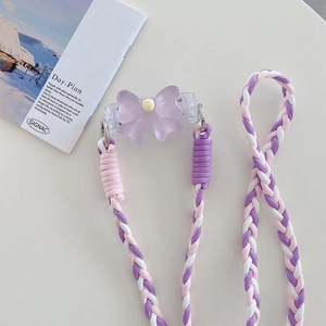 Close-up of a purple bow clip and colorful woven lanyard with sturdy metal rings