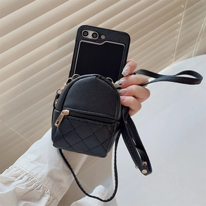 Close-up of black quilted leather mini backpack phone case with golden zipper detail