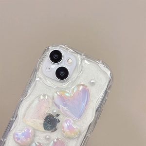 Macro shot of 3D laser holographic hearts with glitter and pearls on phone case