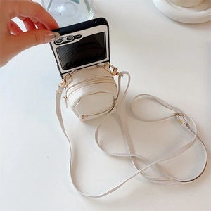 Detailed view of white mini backpack phone case with zipper pocket and adjustable strap