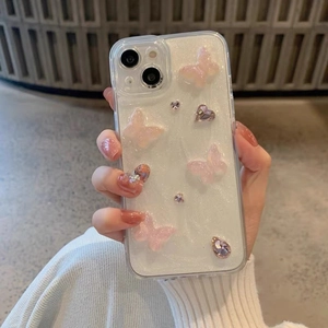 Pink resin butterfly and rhinestone heart design on a glittery iPhone protective case