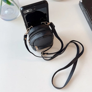 Detail view of black lychee leather mini backpack phone case with adjustable strap