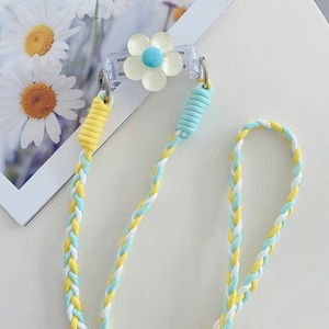 Close-up of woven three-color phone strap with yellow flower clip and sturdy connectors