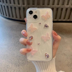 Close-up of pearl white glitter phone case with 3D pink butterflies and gemstones