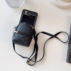 Detail view of black quilted faux leather mini crossbody bag with metal zipper and strap