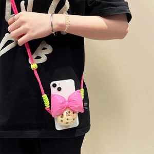Pink braided crossbody phone strap with plush cookie doll and oversized glossy bow charm