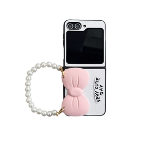 Samsung Z Flip 5 case with pink bow, pearl hand chain, and cute letter design