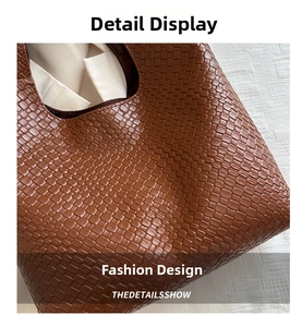 Macro detail of the brown woven leather pattern on a French style shoulder tote bag