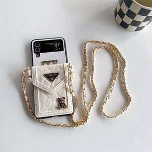 Detail of white litchi leather Z Flip case with mini purse, pearl decor, and bear charm