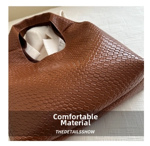 Close-up of brown woven faux leather tote bag with detailed basket weave texture