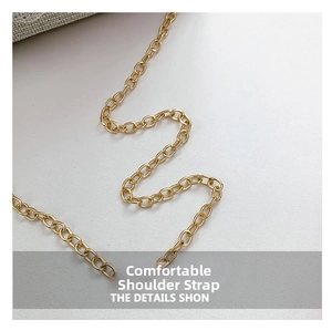 Close-up of bright golden metal chain strap with fine link craftsmanship and smooth finish