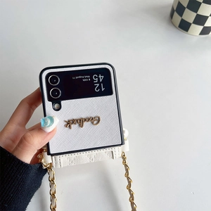 White litchi texture foldable phone case with metal Goodluck letters and a crossbody chain