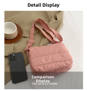 Detail view of pink quilted shoulder bag showing texture and size with a phone reference