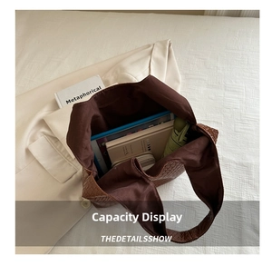 Interior view of brown woven tote bag showing space for tablet, notebook, and umbrella