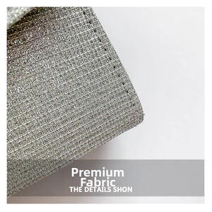 Detailed macro view of silver glitter fabric with fine stitching for trendy square bag