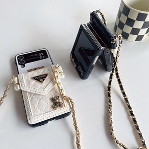 Detail of quilted leather phone case with metal bear and crossbody chain for Z Flip 5