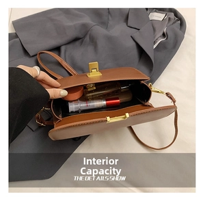 Detail view of the brown leather shoulder bag interior showing capacity for cosmetics